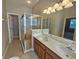 Double vanity bathroom with shower and large mirror at 5119 Santa Ana Dr, Orlando, FL 32837