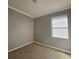 Well-lit bedroom featuring carpet and window blinds at 5119 Santa Ana Dr, Orlando, FL 32837