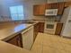 Kitchen with wood cabinets and white appliances at 5119 Santa Ana Dr, Orlando, FL 32837