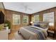 Bedroom with wood-paneled walls and new laminate flooring at 5217 N Apopka Vineland Rd, Orlando, FL 32818