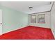 Spacious bedroom with red carpet and large windows at 5217 N Apopka Vineland Rd, Orlando, FL 32818