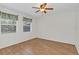 Empty bedroom with hardwood floors and large windows at 5217 N Apopka Vineland Rd, Orlando, FL 32818