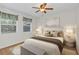 Well-lit bedroom with hardwood floors and ceiling fan at 5217 N Apopka Vineland Rd, Orlando, FL 32818