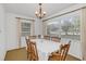 Bright dining room with wood table and chairs, and large windows at 5217 N Apopka Vineland Rd, Orlando, FL 32818