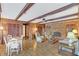 Bright living room with hardwood floors, exposed beams, and a brick fireplace at 5217 N Apopka Vineland Rd, Orlando, FL 32818