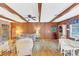 Living room with wood paneling, exposed beams, and seating at 5217 N Apopka Vineland Rd, Orlando, FL 32818