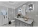 Modern bathroom with gray vanity and marble countertop at 539 Pinehurst Cv, Kissimmee, FL 34758