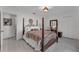 Bright bedroom with floral bedding and a wooden poster bed at 539 Pinehurst Cv, Kissimmee, FL 34758