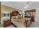 Bedroom with king-size bed and elegant wood furniture at 539 Pinehurst Cv, Kissimmee, FL 34758