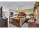 Main bedroom with a large bed, ceiling fan, and dark wood furniture at 539 Pinehurst Cv, Kissimmee, FL 34758