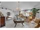 Living room featuring a large window, chandelier, and comfy furniture at 539 Pinehurst Cv, Kissimmee, FL 34758