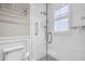 Clean bathroom with white tile, glass shower, and checkerboard floor at 567 Osceola Ave, Winter Park, FL 32789