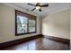 Bright bedroom with hardwood floors and a large window offering treetop views at 567 Osceola Ave, Winter Park, FL 32789