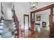 Hardwood floor entryway with staircase and view into living room with fireplace at 567 Osceola Ave, Winter Park, FL 32789