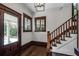 Bright entryway with hardwood floors, wooden staircase, and front door at 567 Osceola Ave, Winter Park, FL 32789