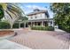 Two-story house with a wrap-around porch and brick driveway at 567 Osceola Ave, Winter Park, FL 32789