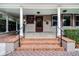 Elegant front porch with brick steps and black railings at 567 Osceola Ave, Winter Park, FL 32789