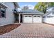 Two-car garage with paver driveway and landscaped walkway at 567 Osceola Ave, Winter Park, FL 32789