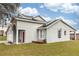 House exterior with grey siding and solar panels at 587 Bluff Pass Dr, Eustis, FL 32726