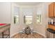 Bright kitchen nook with a bay window and tiled flooring at 587 Bluff Pass Dr, Eustis, FL 32726