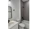 Modern bathroom with gray tile, white vanity, and bathtub at 6579 Sw 132Nd St, Ocala, FL 34473