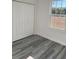 Bright bedroom with double door closet and wood-look flooring at 6579 Sw 132Nd St, Ocala, FL 34473