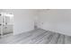 Spacious bedroom with wood-look floors, walk-in closet, and an ensuite bathroom at 6579 Sw 132Nd St, Ocala, FL 34473