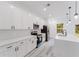 Beautiful white kitchen featuring a large island, stainless steel appliances, and modern pendant lighting at 6579 Sw 132Nd St, Ocala, FL 34473