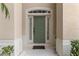 Green front door with sidelights and a decorative arch at 7773 Basnett Cir, Kissimmee, FL 34747