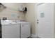 Convenient laundry room with washer, dryer, and shelving at 7773 Basnett Cir, Kissimmee, FL 34747