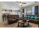 Relaxing living room with brown sectional sofa and a large window at 7773 Basnett Cir, Kissimmee, FL 34747