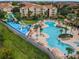 Resort-style pool area with water slides, a playground, and ample lounge chairs at 7773 Basnett Cir, Kissimmee, FL 34747