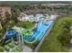 Aerial view of a vibrant water park with slides and a splash pad at 7773 Basnett Cir, Kissimmee, FL 34747