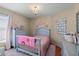 Charming bedroom with a crib and plenty of storage at 7927 Oakstone Ct, Orlando, FL 32822