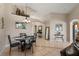 Cozy dining area with a round table and four chairs, adjacent to the living room at 7927 Oakstone Ct, Orlando, FL 32822