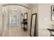 Inviting entryway with tiled floors and a full-length mirror at 7927 Oakstone Ct, Orlando, FL 32822