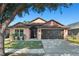 One-story house with pink walls, brown roof, and dark brown garage door at 7927 Oakstone Ct, Orlando, FL 32822