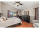 Main bedroom with dresser, large bed, and window at 7927 Oakstone Ct, Orlando, FL 32822