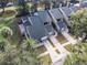 Aerial view of townhouses with gray roofs, private driveways, and lush landscaping at 8133 Citrus Chase Dr, Orlando, FL 32836