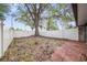 Small, fenced backyard with patio and large tree at 8133 Citrus Chase Dr, Orlando, FL 32836