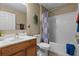 Bathroom with shower/tub combo, wood vanity, and patterned curtain at 856 La Gran Via Lane, Apopka, FL 32703