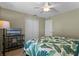 Guest bedroom with leafy bedding, TV, and ceiling fan at 856 La Gran Via Lane, Apopka, FL 32703