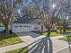 Single-story house with red door and two-car garage at 856 La Gran Via Lane, Apopka, FL 32703