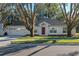 Single-story house with red door and two-car garage at 856 La Gran Via Lane, Apopka, FL 32703