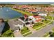 Aerial view showcasing a house with solar panels and a lake at 10631 Royal Cypress Way, Orlando, FL 32836