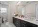 Double vanity bathroom with dark brown cabinets and a toilet at 10631 Royal Cypress Way, Orlando, FL 32836