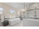 Elegant bathroom with soaking tub and glass shower at 10631 Royal Cypress Way, Orlando, FL 32836