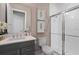 Clean bathroom with gray vanity and walk-in shower at 10631 Royal Cypress Way, Orlando, FL 32836