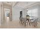 Bright dining room with glass table and gray chairs at 10631 Royal Cypress Way, Orlando, FL 32836