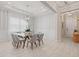 Elegant dining room with a glass table and gray chairs at 10631 Royal Cypress Way, Orlando, FL 32836